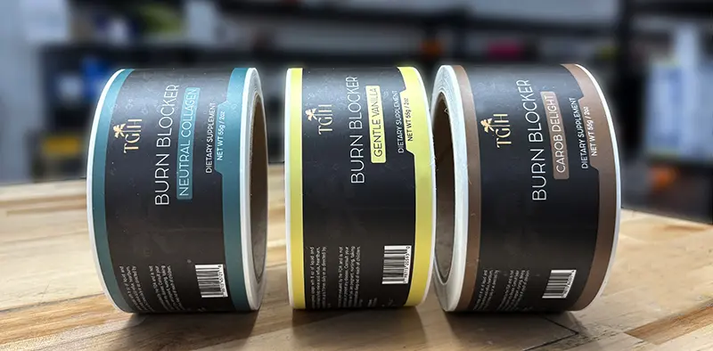 3 rolls of custom labels on a countertop